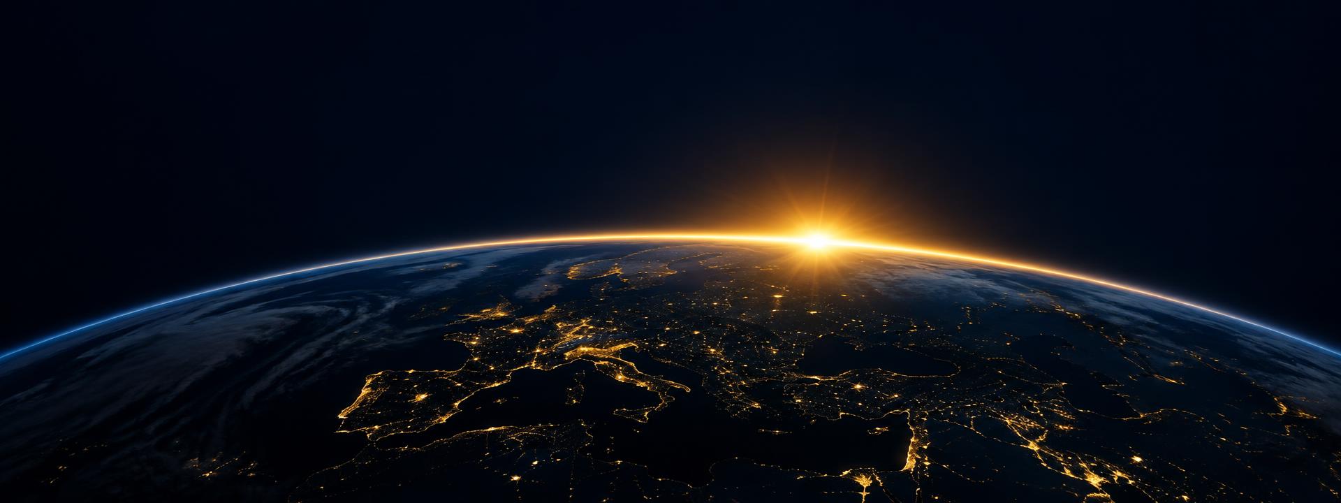 A Terra vista do espaço com o nascer do sol dourado no horizonte
